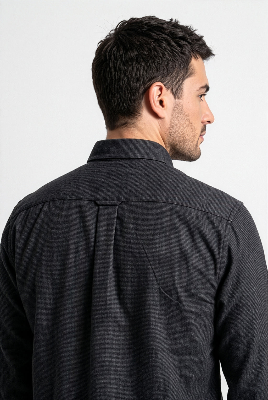 Back yoke and centre pleat detail of charcoal micro-check flannel shirt