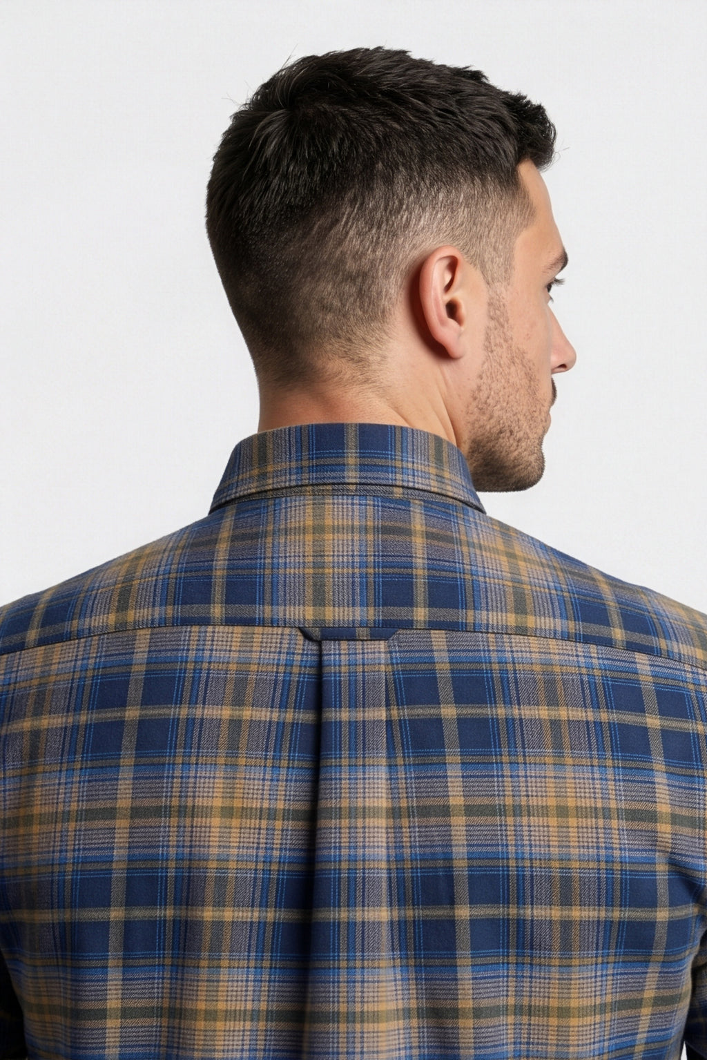 Back yoke and centre pleat detail of navy and tan plaid flannel shirt