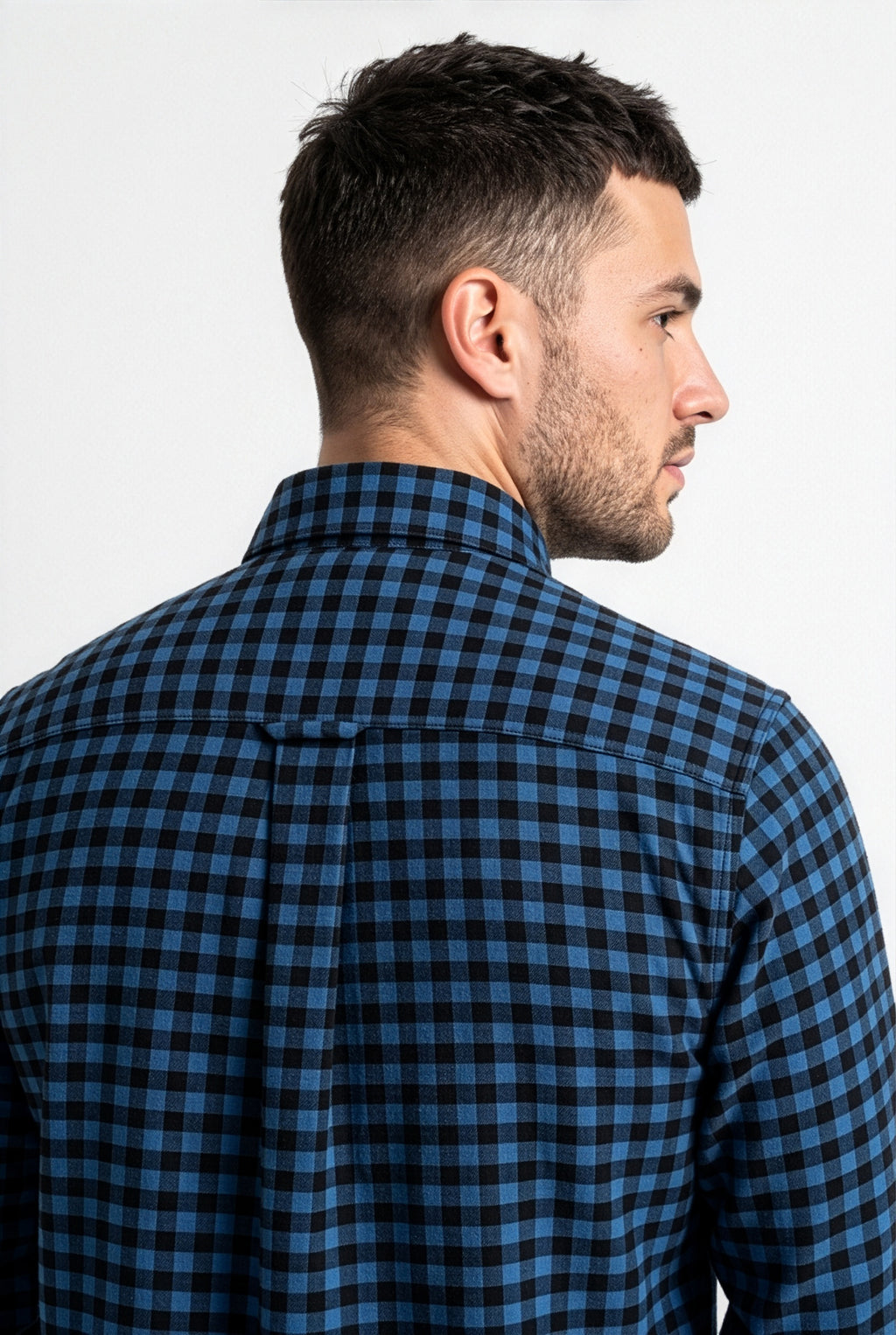 Back yoke and centre pleat detail of blue and black gingham flannel shirt