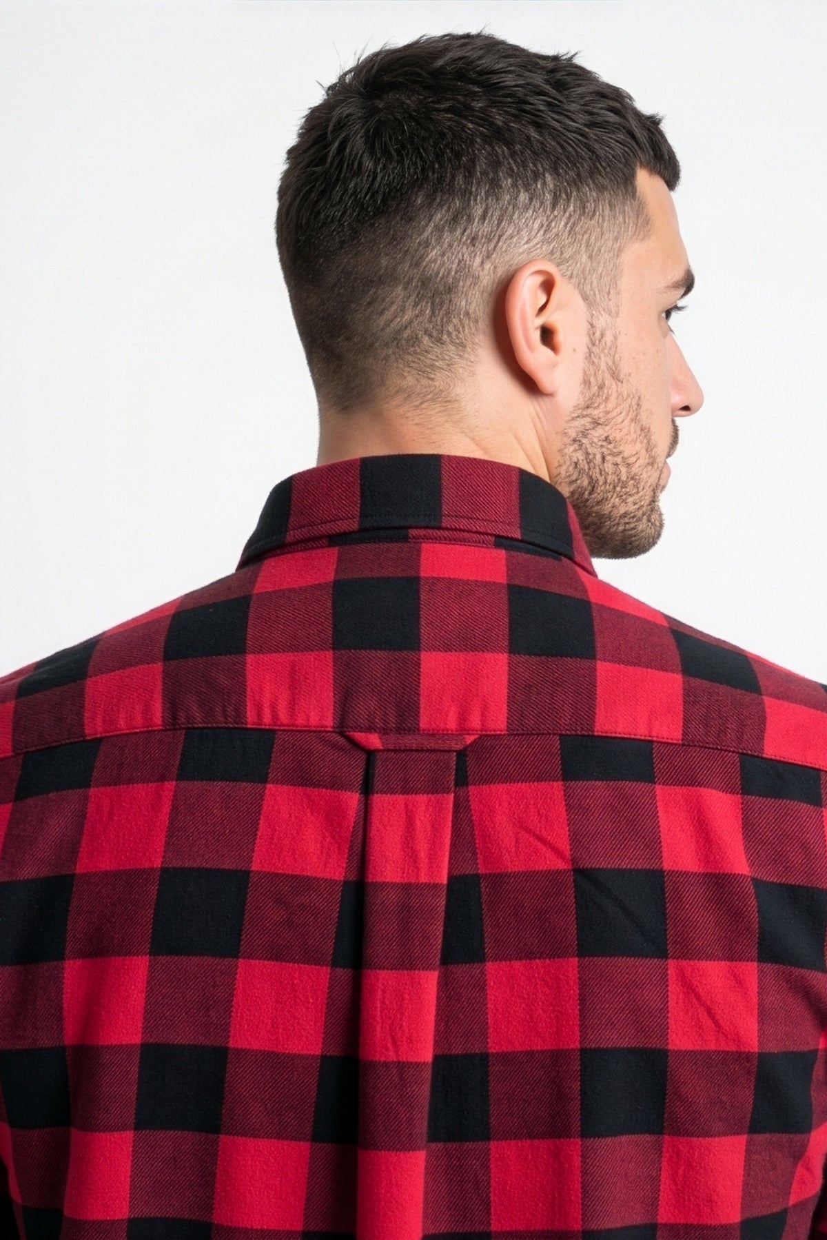 Back yoke and pleat detail of red and black buffalo check flannel shirt