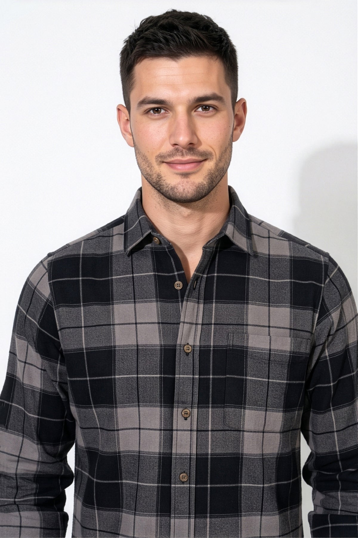 Collar and chest pocket detail of black and grey plaid flannel shirt