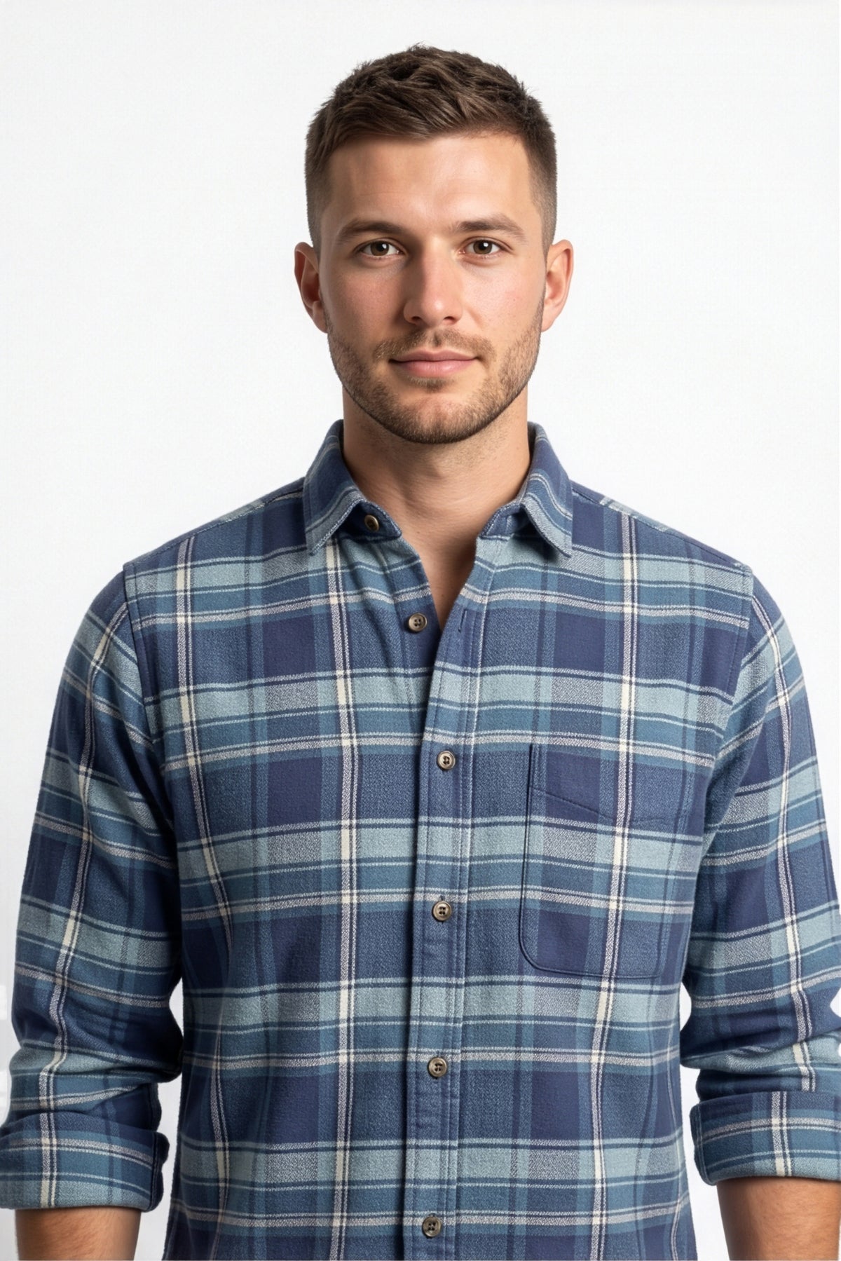 Collar and chest pocket detail of navy and light blue plaid flannel shirt