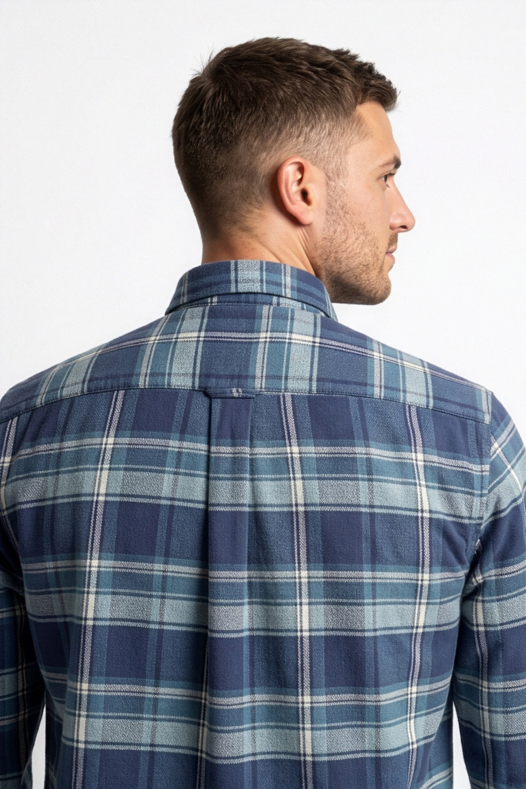 Back yoke and centre pleat detail of navy and light blue plaid flannel shirt