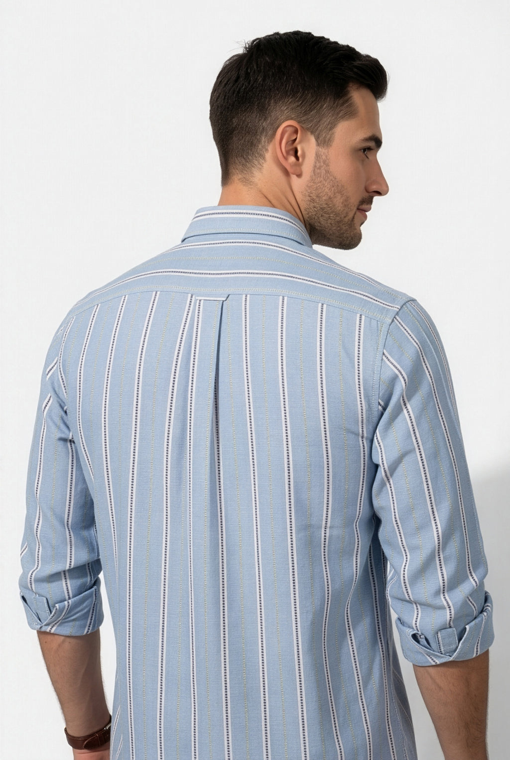Back yoke and centre pleat detail of light blue striped cotton dobby shirt