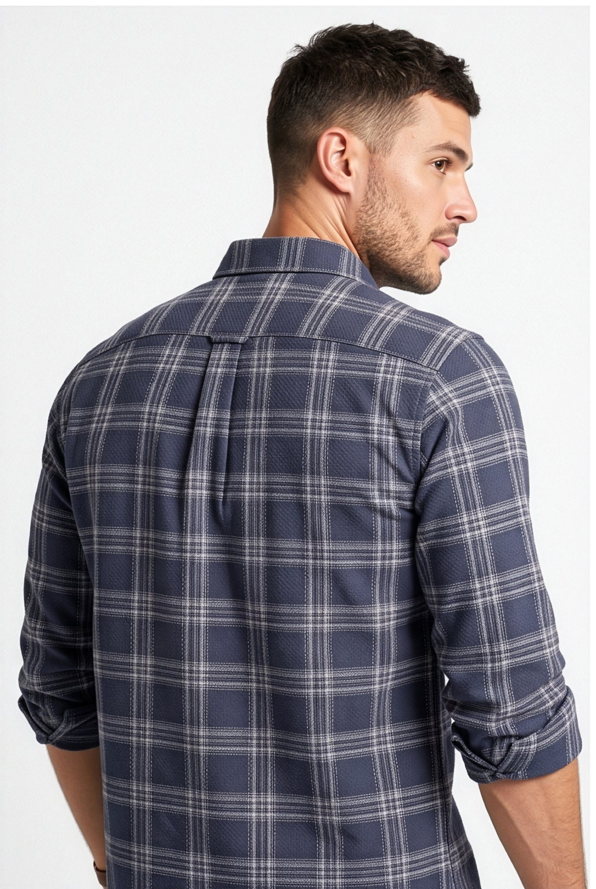Back yoke and centre pleat detail of navy and grey plaid cotton dobby shirt