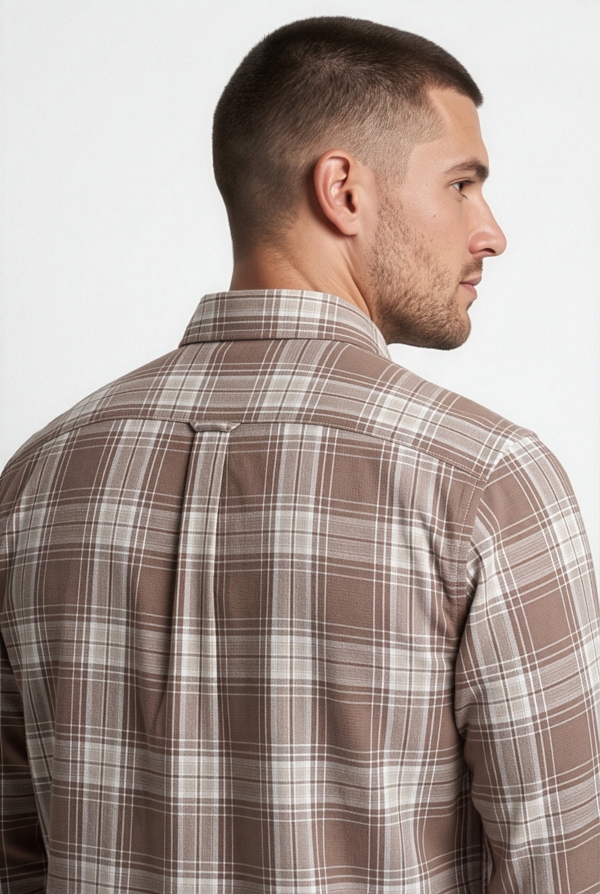 Back yoke and centre pleat detail of brown and cream plaid cotton dobby shirt